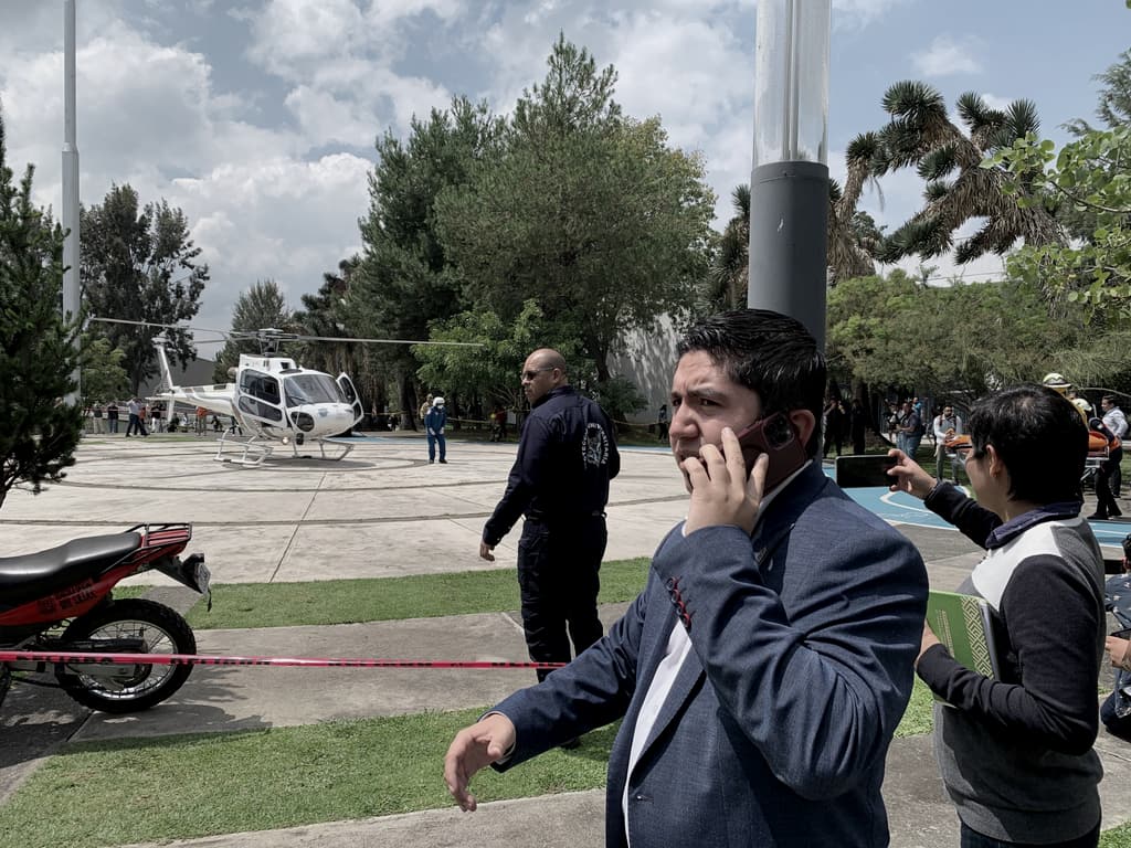 Salvador J. Vazquez Villa takes a call on an esplanade where a helicopter has landed.